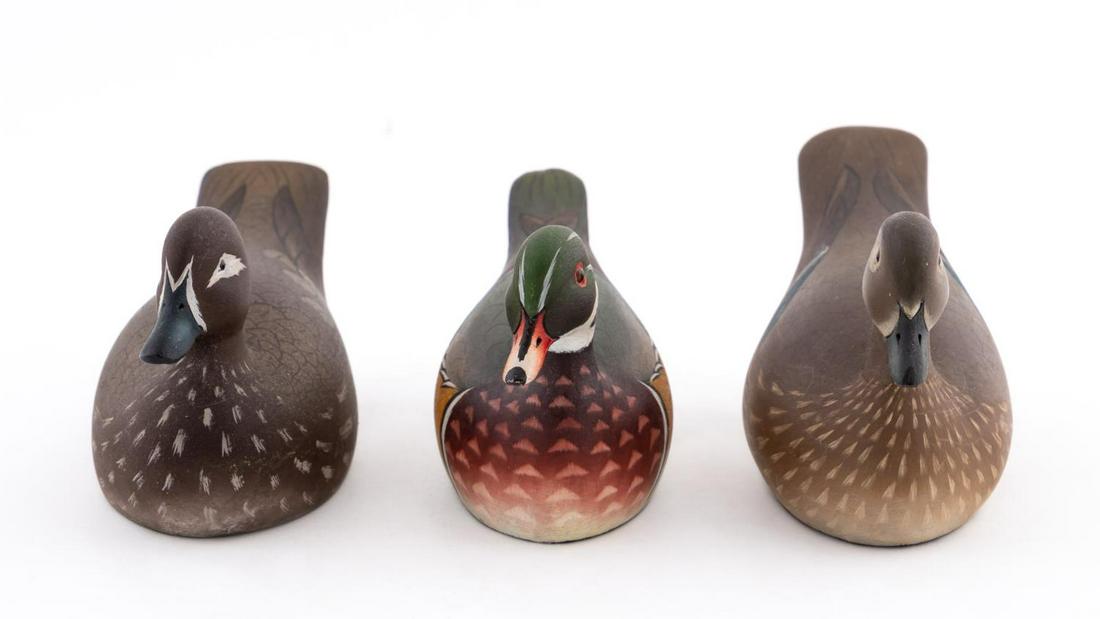 THREE KEN HARRIS MINIATURE DUCK DECOYS: Ken Harris (American/New York, 1905-1981). Two wood duck hens and one drake, carved and painted wood. Each marked underneath "MADE BY/KEN HARRIS/WOODVILLE NY".Longest w. 7"