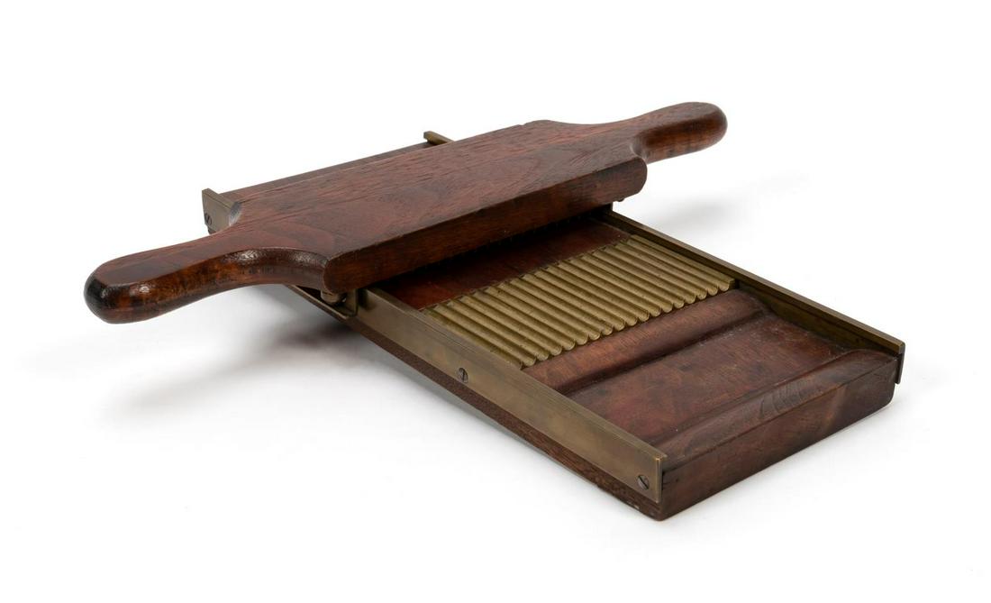 19TH CENTURY WALNUT AND BRASS PILL ROLLER: Likely British, 19th century. Two-piece walnut pill roller having grooved brass plates and sides. Unmarked. Approx. with the roller attached, 2.5", w. 13.75", d. 12". Provenance: Items deaccessioned f