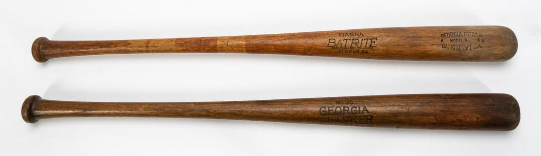 TWO HANNA BASEBALL BATS, GEORGIA CRACKER & DRIVER: Hanna Manufacturing Company (American), 1920s-1930s. Two wooden baseball bats comprising of one Georgia Cracker bat and one Georgia driver bat. Marks to side of body. Provenance: Items deaccessioned f