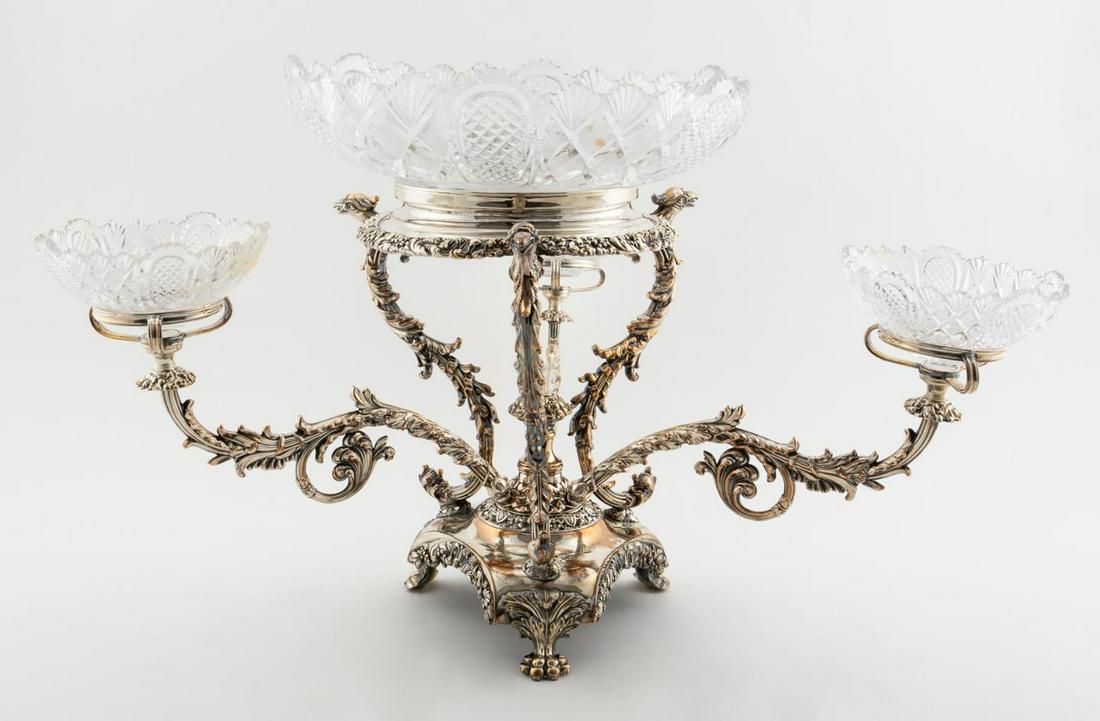 SILVERPLATE & CUT GLASS GRYPHON FORM EPERGNE: Likely English, early 20th century. A unique three arm epergne with gryphon form supports, cut glass bowls and resting on three paw feet. Apparently unmarked. Approx: h. 12.5", w. 25".