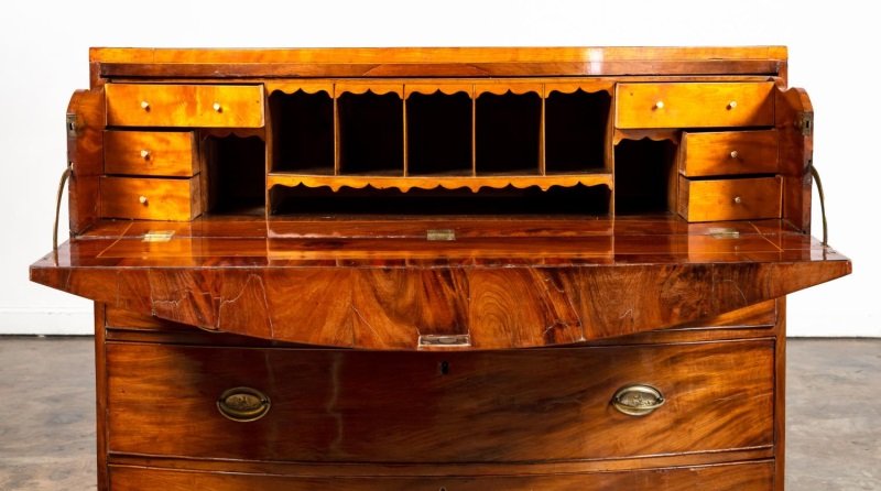 GEORGE III BOW FRONT BUTLERS DESK: English, first half 19th century. George III Hepplewhite style bow front butlers desk / secretary with inlay to top drawer and edges. Apparently unmarked. Approx. h. 45.5", w. 49.5", d. 23.5".