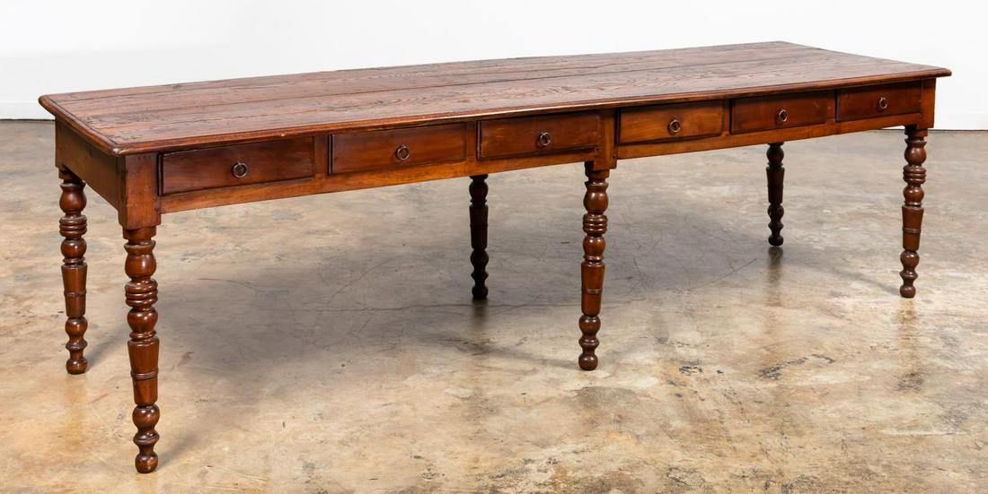 GEORGE III STYLE HABERDASHERY TABLE: George III style haberdashery table with oak top on fruitwood base, with nine frieze drawers and supported on six turned legs. Apparently made using some reclaimed elements.Approx. h. 31", l, 109", d.