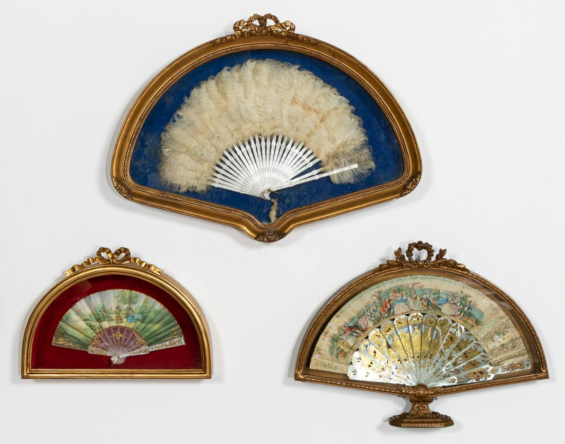 GROUP OF THREE ANTIQUE FRAMED FANS, ONE MOP: Group of three antique framed fans, two with figural scenes and gilt decorative details and one with feathers. All three in ornate shadowbox frames. Apparently unmarked.