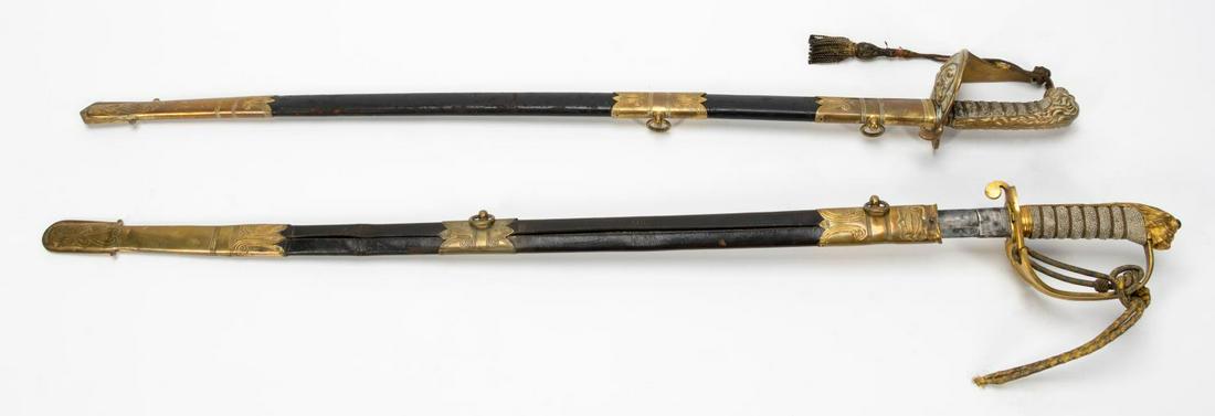 TWO ENGLISH NAVAL DRESS SWORDS: English, early 20th century. Two English naval officers dress swords having gilt brass hilts with shagreen grips, lion's head pommels and crowned fouled anchor motifs, in brass fitted black leather sc