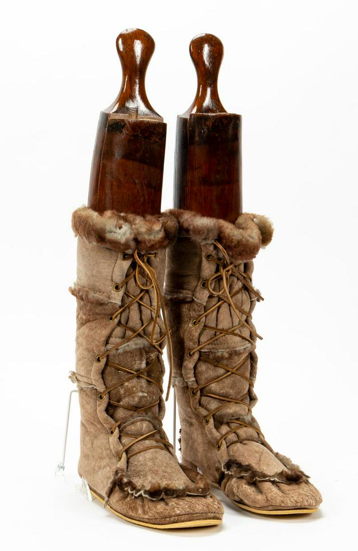 PR. MAXWELL LONDON WOOD SHOE FORMS WITH FUR BOOTS: Maxwell London (English). Carved wooden boot forms accompanied by lace up fur boots. Forms having maker's mark.Approx. h. 25.125" (form in boot), h. of boot 14.5", d. of sole 10.875".