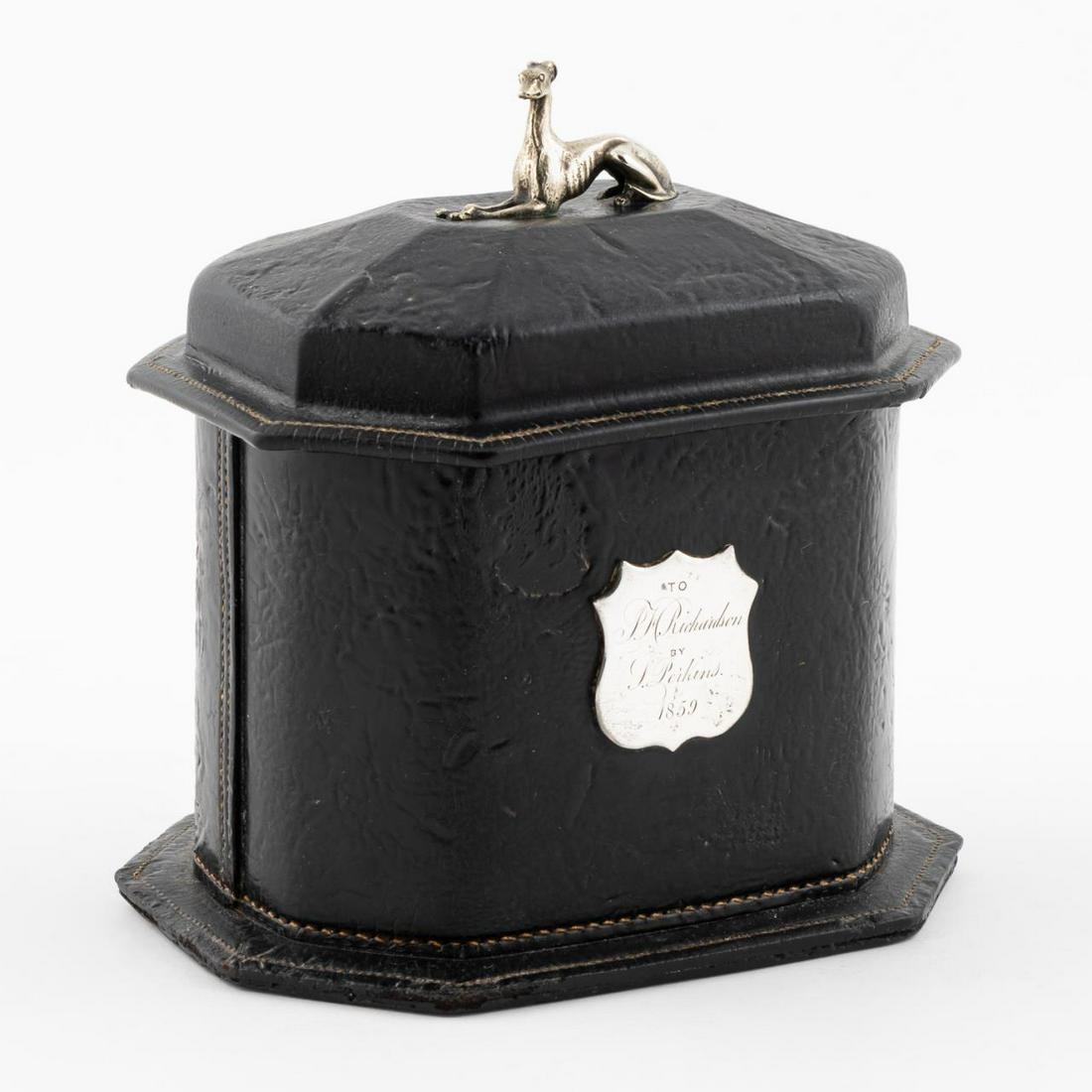 HEWITT'S TOBACCO PRESENTATION BOX, CIRCA 1852: Frederic William Hewitt, circa 1852. A Hewitt's Universal leather tobacco presentation box with a silvered grey hound finial, tin lined interior and silver presentation shield presented to "P.H. Richa