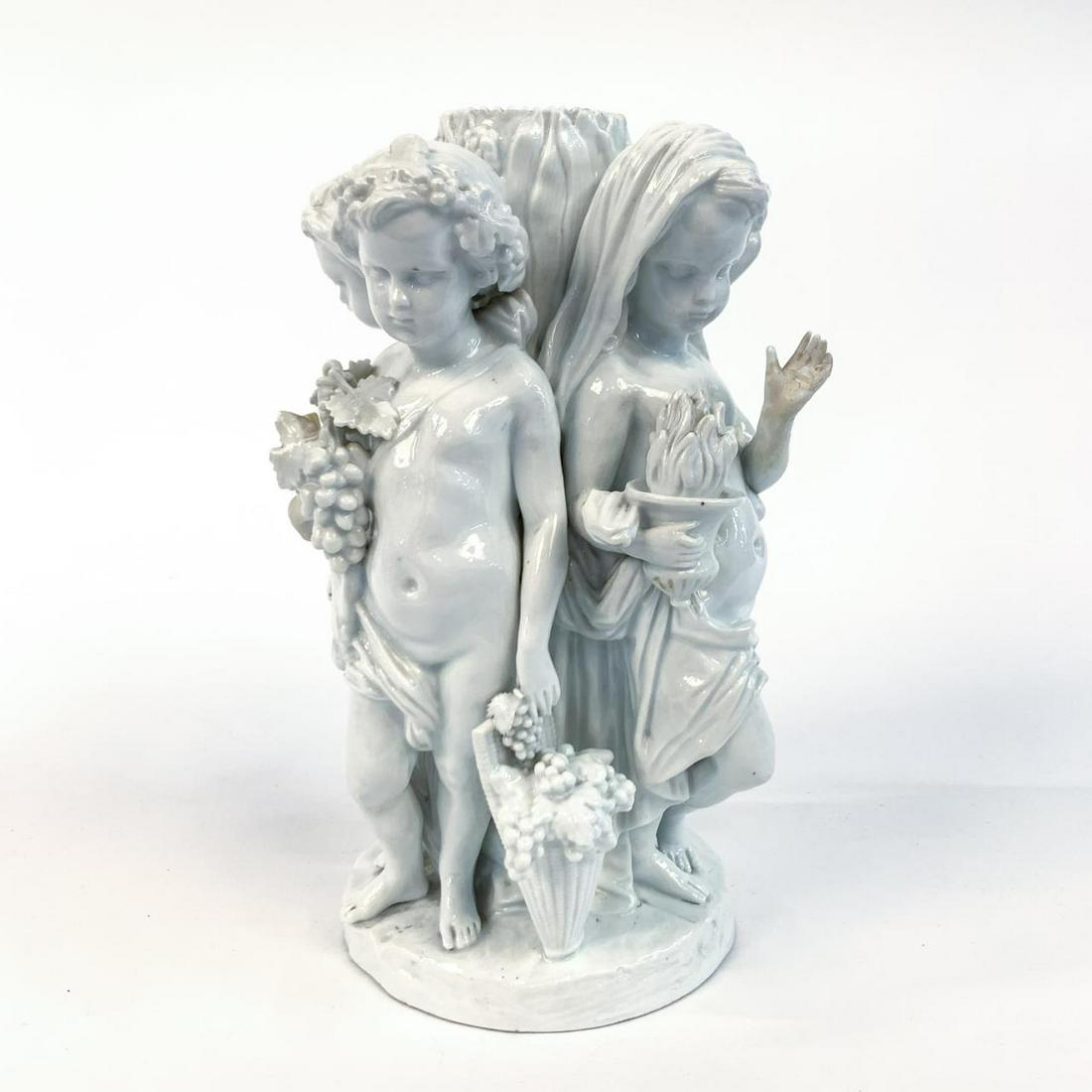 MEISSEN BLANC DE CHINE FIGURAL PORCELAIN GROUPING: Meissen (German, founded 1710), late 19th century. A porcelain centerpiece blanc de chine figural grouping of young children, original a basket centerpiece. Marked to underside with blue crossed sword