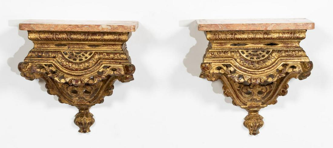 PR. ITALIAN MARBLE & GILTWOOD WALL BRACKETS: Italian, 20th century. Pair of Baroque style rouge marble and gilt wall brackets. Apparently unmarked.Approx. h. 11", w. 10.5", d. 5.375".