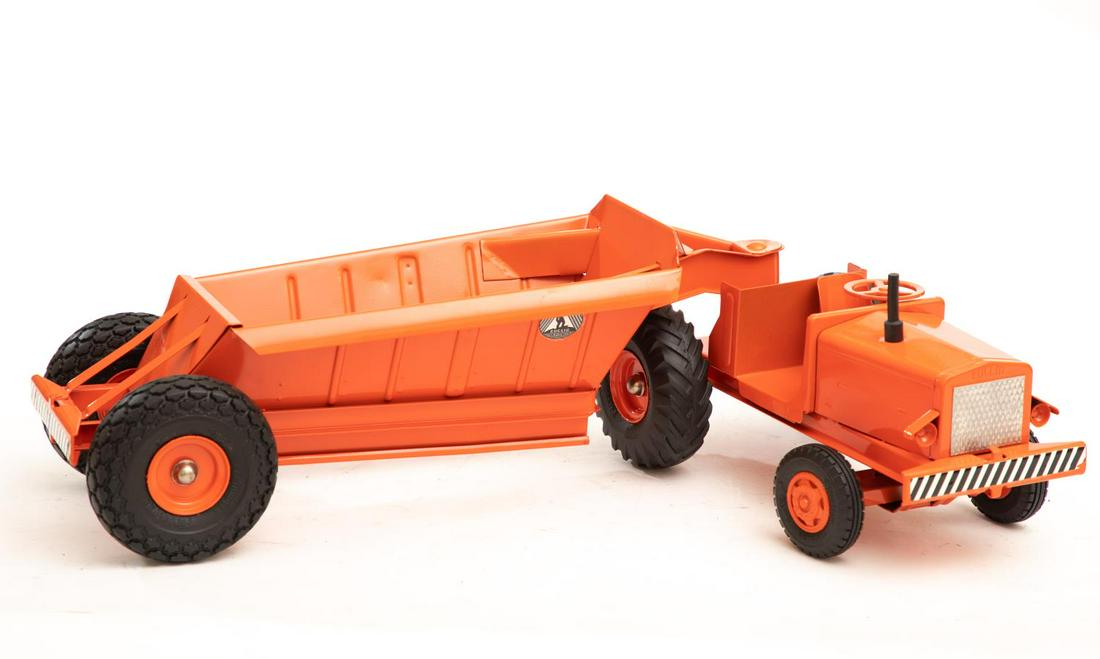 Orange Model Earth Mover by Doepke: Diecast model toy truck. Approx. 26"L Please note: This lot is not housed at Ahlers & Ogletree Auction Gallery. Pickup address will be supplied to winning bidder. All purchased lots MUST be picked up 