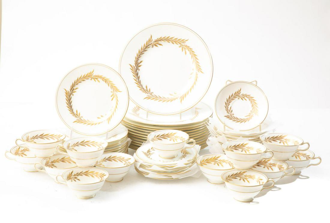 Set, Minton "Malta" English Bone China Dinnerware: Ivory with gold leaf wreath and gold rim. Including 13 dinner plates, 12 salad plates, 8 bread plates, 13 cups, 13 saucers. Please note: This lot is not housed at Ahlers & Ogletree Auction Gallery. Pi
