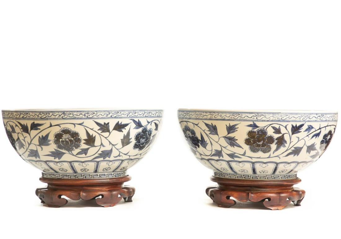 Pair, Chinese Blue and White Porcelain Punch Bowls: Chinese, 20th century. Pair of blue and white porcelain punch bowls on carved wood stands. Unmarked. Approx. diam. 15.75", h. 9.5" (on stand). Please note: This lot is not housed at Ahlers & Ogletree 
