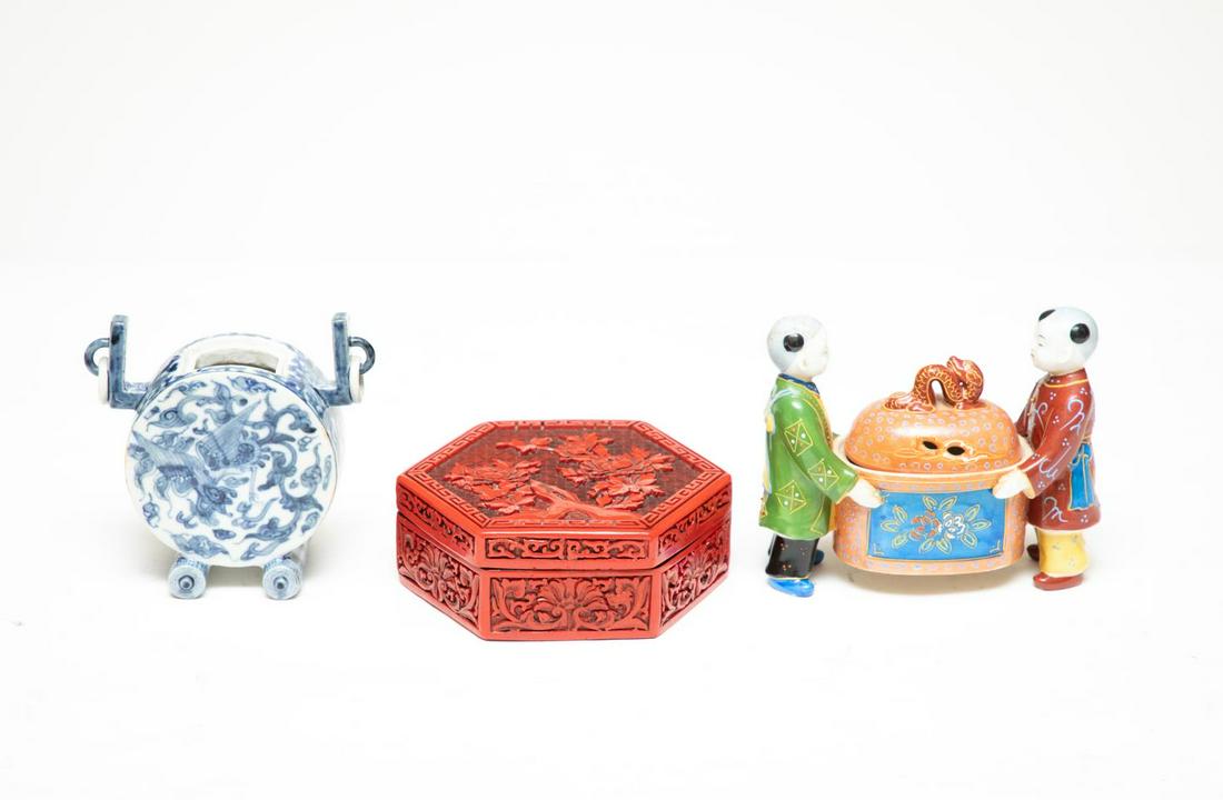 Group of 3 Chinese and Chinoiserie Style Items: Cinnabar box (w. 6.5"), figural box (w. 7"), and a blue and white vase with ring handles (w. 5.5"). Please note: This lot is not housed at Ahlers & Ogletree Auction Gallery. Pickup address will be sup
