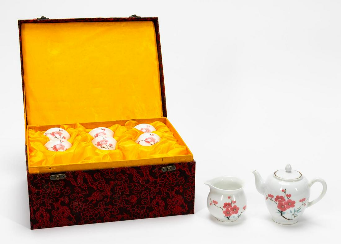 8PC CHINESE CHERRY BLOSSOM MOTIF PORCELAIN TEA SET: Chinese. Diminutive white porcelain tea set decorated with cherry blossoms comprising a tea pot, jug or pitcher and six tea cups. Jingdezhen Zhi type mark to the underside of all. Approx. of the teapo