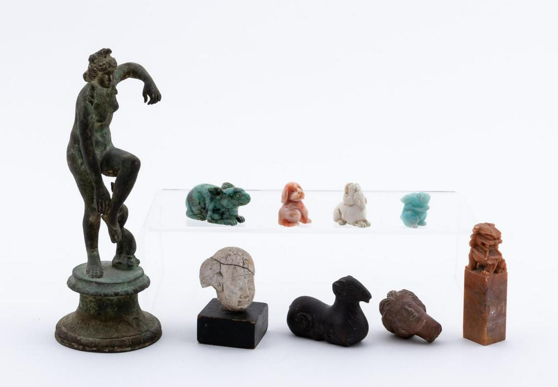 NINE PIECES, ANCIENT STYLE DECORATIVE OBJECTS: Ancient and Archaic style objects including "Aphrodite Untying her Sandal" in heavily patinated bronze, three stone and bone rabbits and dogs, bronze ram, Chinese stone seal, and two ceramic heads anc