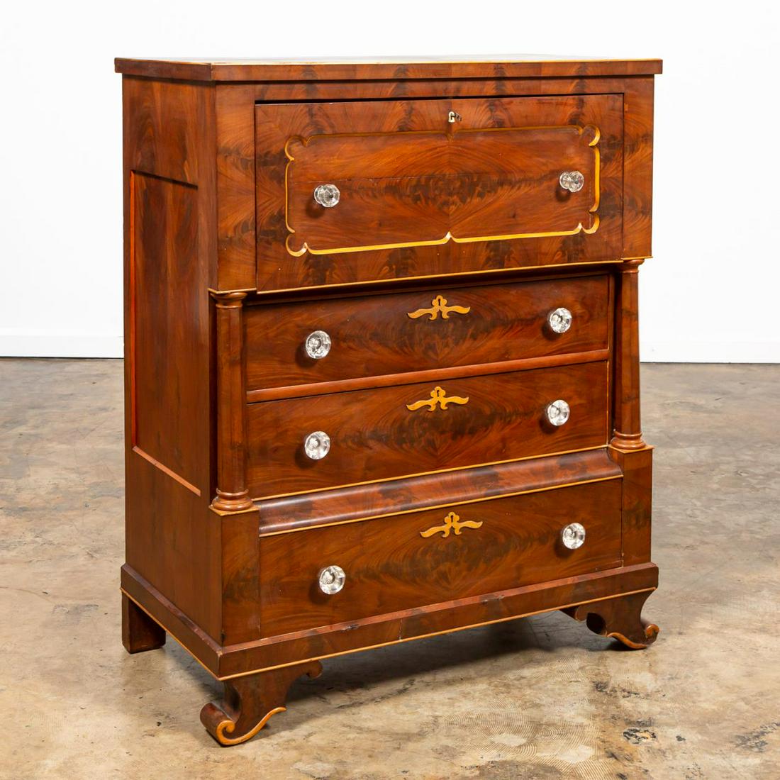 19TH C. AMERICAN EMPIRE MAHOGANY BUTLER'S DESK: American, mid-19th century. Empire butler's desk having a vivid flame mahogany veneer, Sandwich glass knobs, paneled fall front that opens to reveal a fitted interior with concealed drawers, two lower