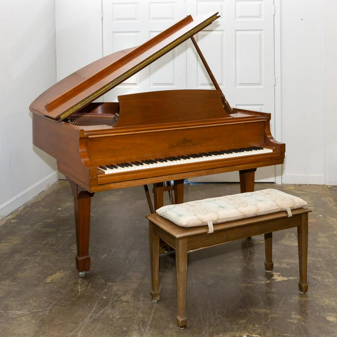 STEINWAY & SONS GRAND MODEL M WALNUT PIANO: Steinway & Sons (American, founded 1853), 1974. Walnut model M grand piano accompanied by bench. Marked to iron plate and fallboard, serial number 435830M. Approx. h. 38", w. 57.25", d. 67".