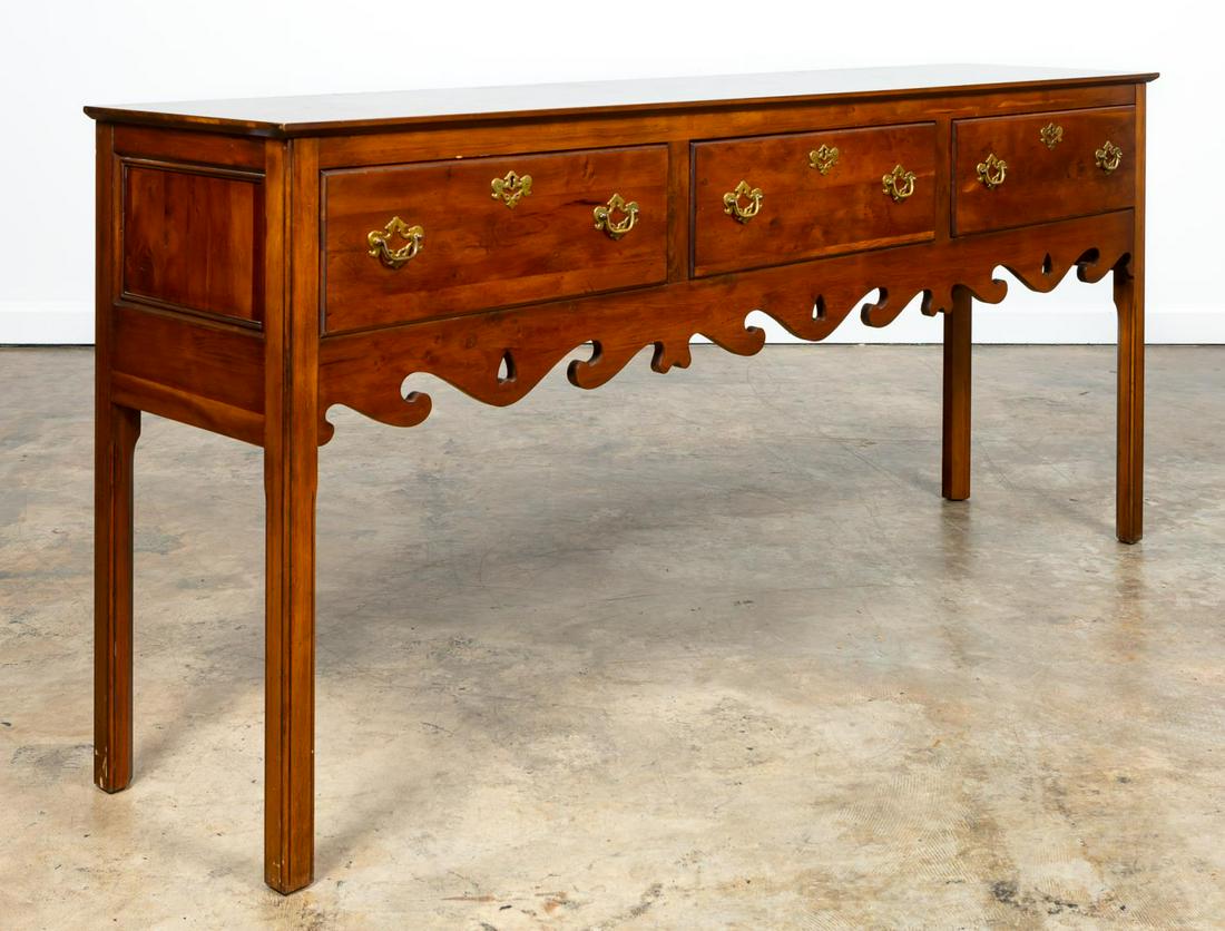 WRIGHT TABLE CO. PINE CHIPPENDALE STYLE SIDEBOARD: Wright Table Company (American, 1971-2015), late 20th century. Pine sideboard or buffet in the Chippendale taste having three-drawers with brass hardware; pierced apron, and rising on square legs. Tag