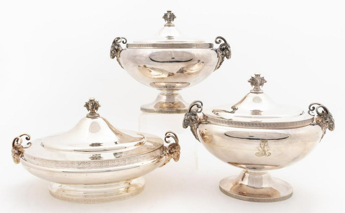 3 PCS, GORHAM SILVERPLATE TUREENS, RAMS HEAD: Gorham (Rhode Island, founded 1831). Set of three silverplate tureens, each having oval bowl with ram's head handles, Greek key border on rim and foot, and finial with ram and bull masks. Shorter ture
