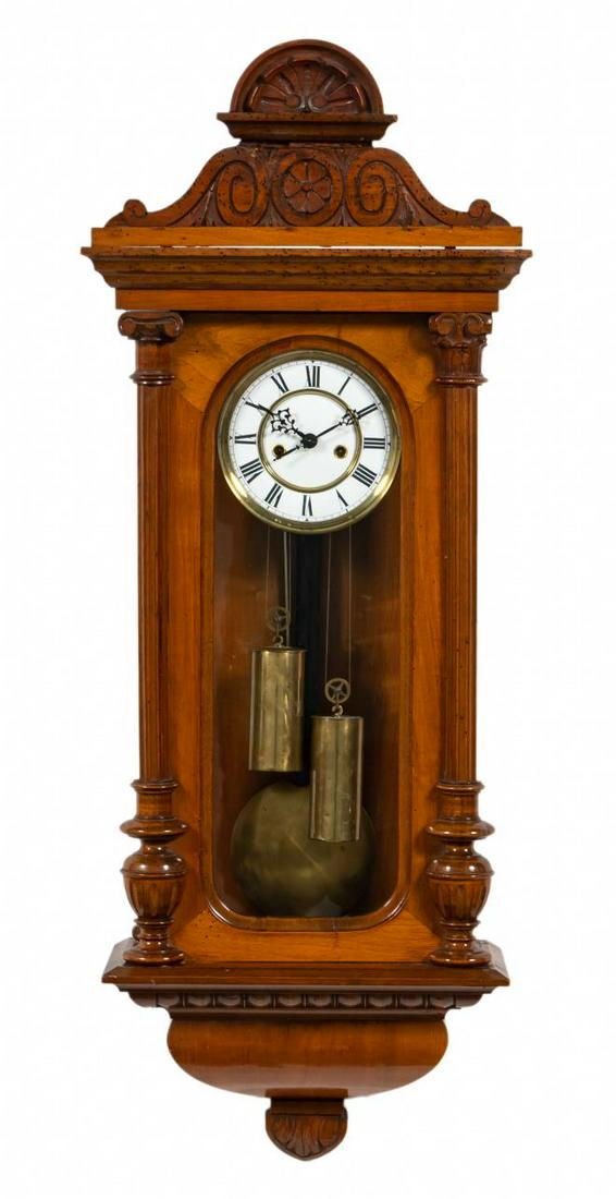 19TH C. AMERICAN REGULATOR WALNUT WALL CLOCK: American, late 19th century. Victorian era regulator clock having a walnut case with carved arched pediment, fluted pilasters flanking the glazed door, and painted porcelain dial. Image of the Wright