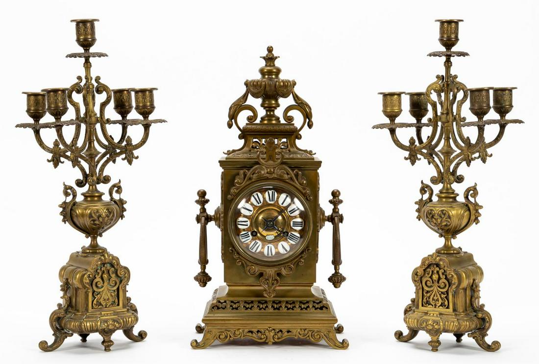 TIFFANY & CO. CLOCK AND ASSOCIATED CANDELABRA, 3PC: Tiffany & Co. (American, founded 1837), late 19th to early 20th century. Three piece bronze garniture set comprising a Tiffany & Co. clock with rectangular case surmounted by a draped urn, ringed hand