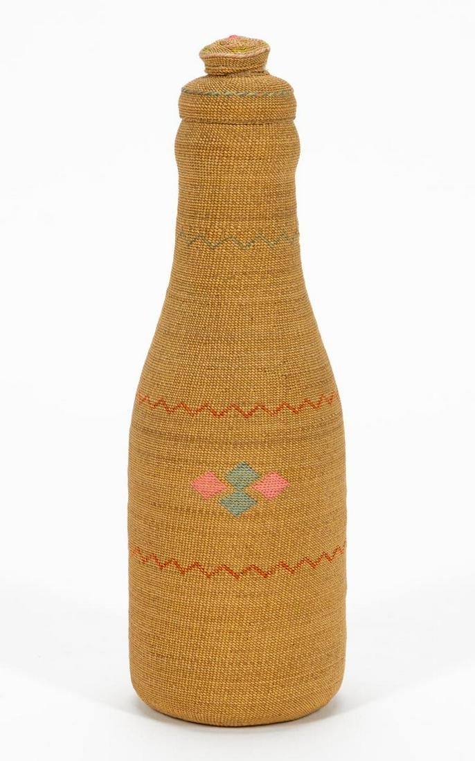 ALEUTIAN ISLAND SMALL BASKETRY COVER BOTTLE: Native American, 20th century. Aleutian Island finely woven and twined basketry bottle with lozenge and chevron pattern. Apparently unmarked. Approx. 6.375".