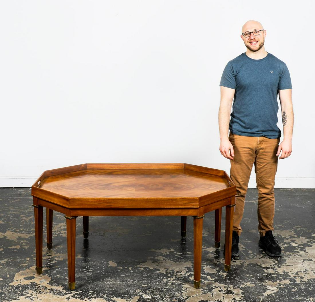 HENREDON RALPH LAUREN OCTAGONAL COCKTAIL TABLE: Henredon (American, founded 1945), Ralph Lauren Home (American, founded 1967), late 20th century. Oversized octagonal form flame mahogany cocktail or coffee table having a faux tray top and rising on 