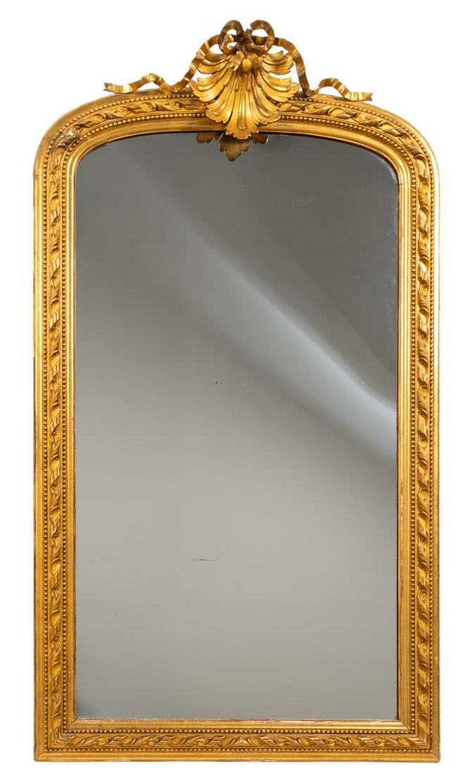 LARGE BAROQUE STYLE GILTWOOD SHELL ACCENT MIRROR: Italian, 20th century. Large baroque style gilt wood mirror with shell and bow accents. Apparently unmarked. Approx. h. 71.5", w. 41".