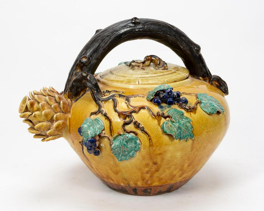 ITALIAN MAJOLICA GRAPEVINE MOTIF OVERSIZED TEAPOT: Italian, 20th century. Oversized majolica grape and artichoke tea pot with vine handle. Apparently unmarked. Approx. h. 16.5", w. 19.5".