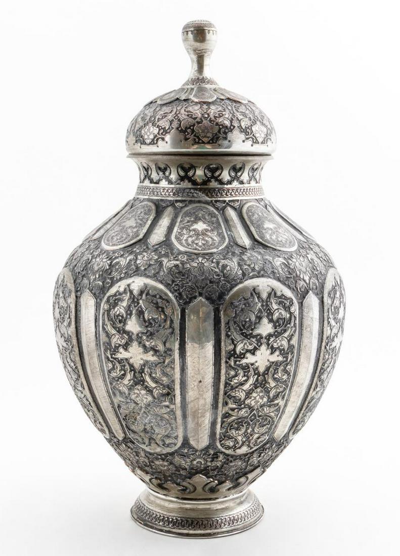 INDIAN SILVER OVER COPPER ORNATE LIDDED URN: Indian. Antiqued silver on copper engraved and repousse lidded urn with ornate floral design. Apparently unmarked. Approx. h. 19.625", w. 10.5".