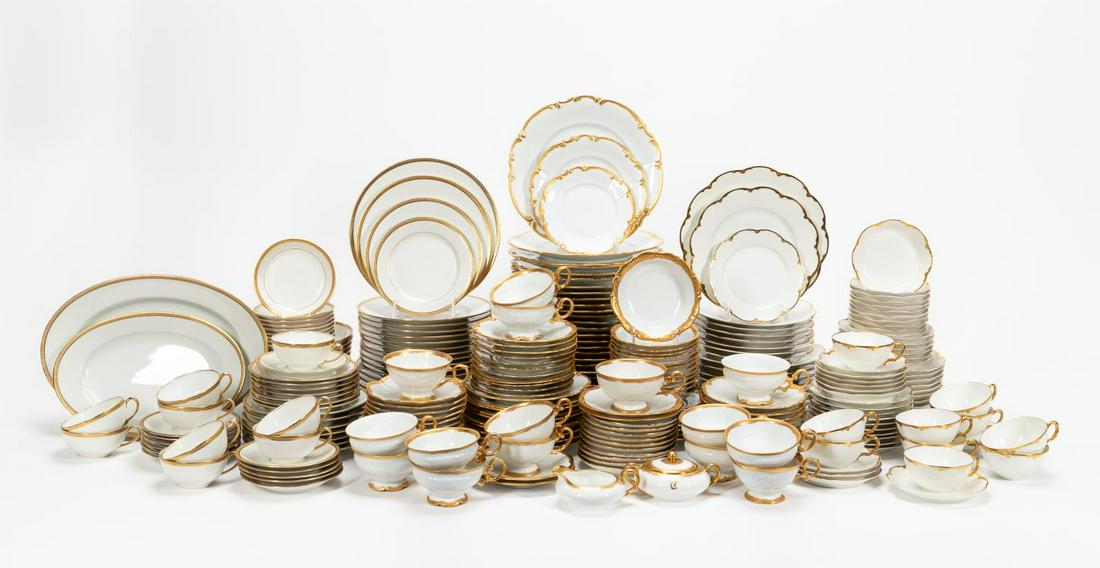 232 PCS, LARGE SET WHITE & GOLD DINNER SERVICE: Mostly continental, 20th century. Assembled set of white and gilded porcelain china including Limoges, Hutschenreuther, Haviland, and other manufacturers, comprising forty two dinner plates, thirty fo