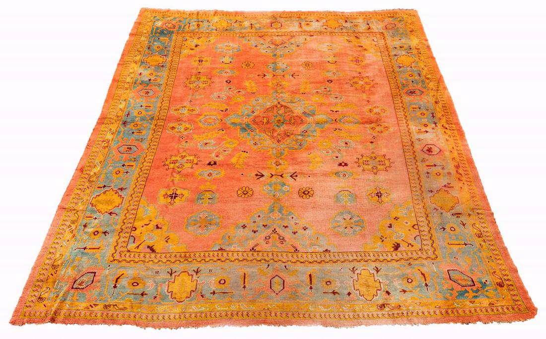 HAND WOVEN OUSHAK ROOM SIZE CARPET: Turkish. A hand woven Oushak room size area rug with floral pattern on orange field. Approx. 14 '8" x 10' 2"