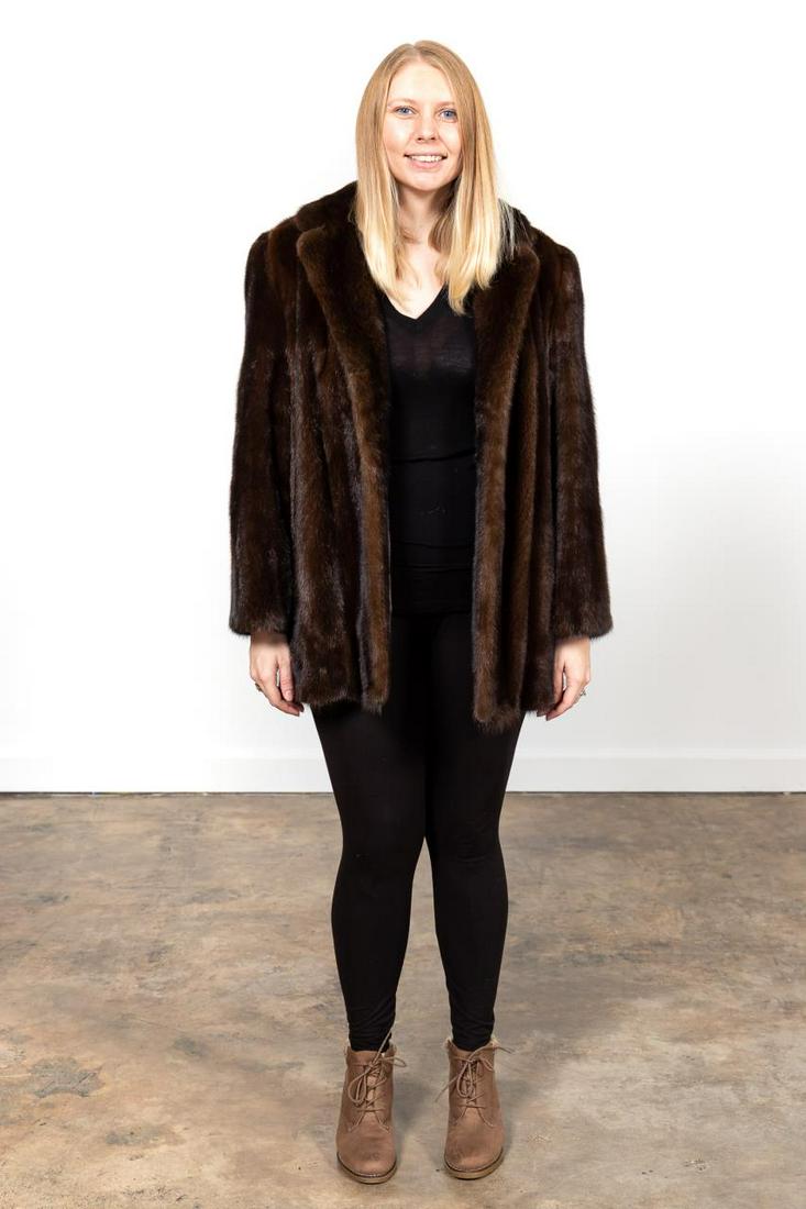 LADIES MAHOGANY MINK HIP LENGTH FUR COAT: Rich's (American, founded 1867). Ladies mahogany mink fur coat having a notched collar, and hook and eye closures. "Distinctive Furs by Rich's" and The Fur Vault New York"" labels to the lining. Appro