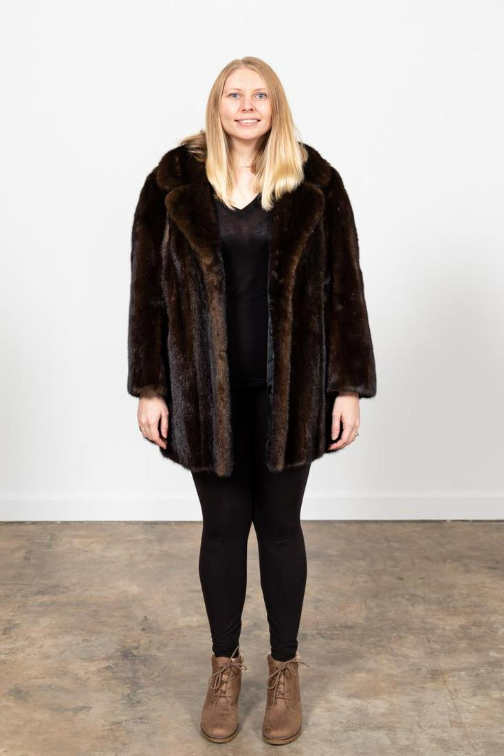 VINTAGE LADIES MAHOGANY MINK FUR STROLLER COAT: Le Parisien (American, mid-20th century). Ladies brown mahogany mink fur stroller coat having a notched collar. Label to the lining. Approx. flat measurements: shoulder 20", sleeve 23", bust 24", tota