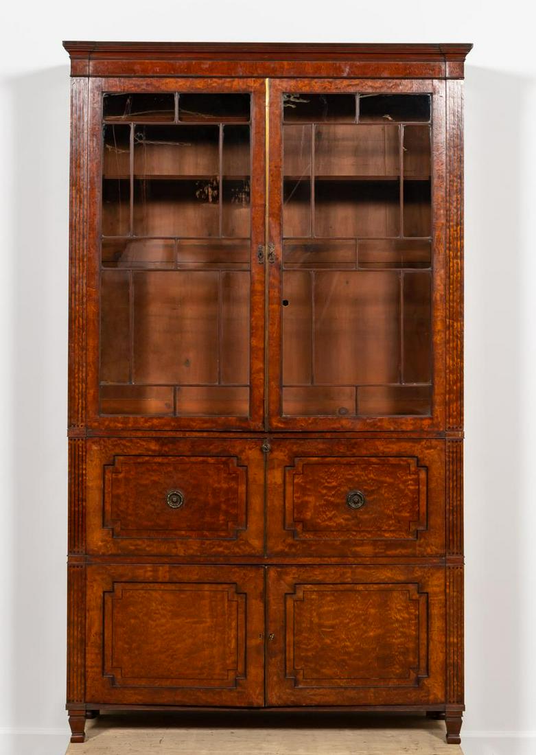 LARGE REGENCY WALNUT SECRETAIRE BOOKCASE: English, 19th century. Large Regency/William IV walnut and ebony inlaid secretarie bookcase, now fitted as a media cabinet, having a shaped cornice, double astragal glazed doors revealing a fitted int