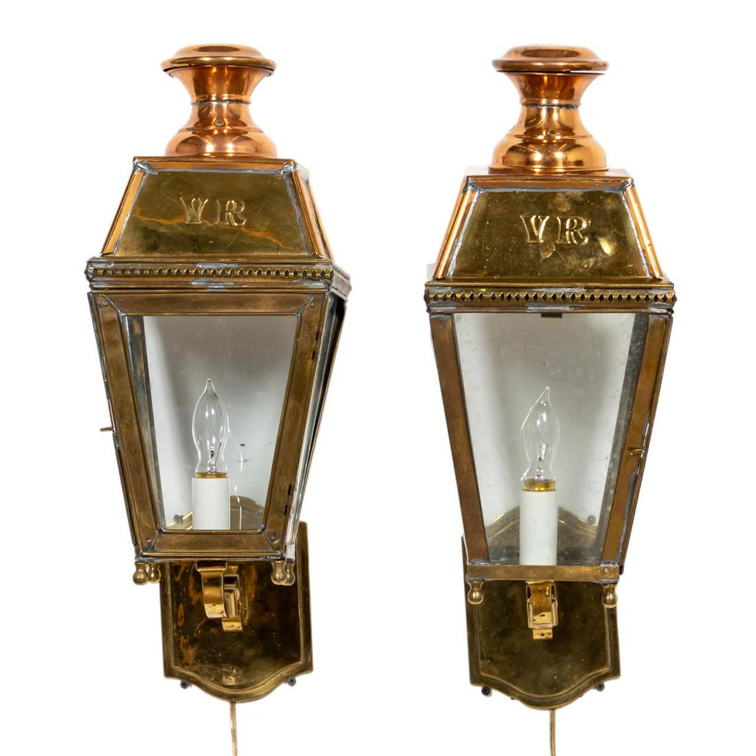 PAIR, 19TH C. 'VR' COPPER & BRASS WALL LANTERNS: English, late 19th century. Pair of copper and brass lanterns, of tapering form, each decorated with 'VR' (Victoria Regina), now electrified, on a scrolling wall bracket. Unmarked. Approx. of one, h. 