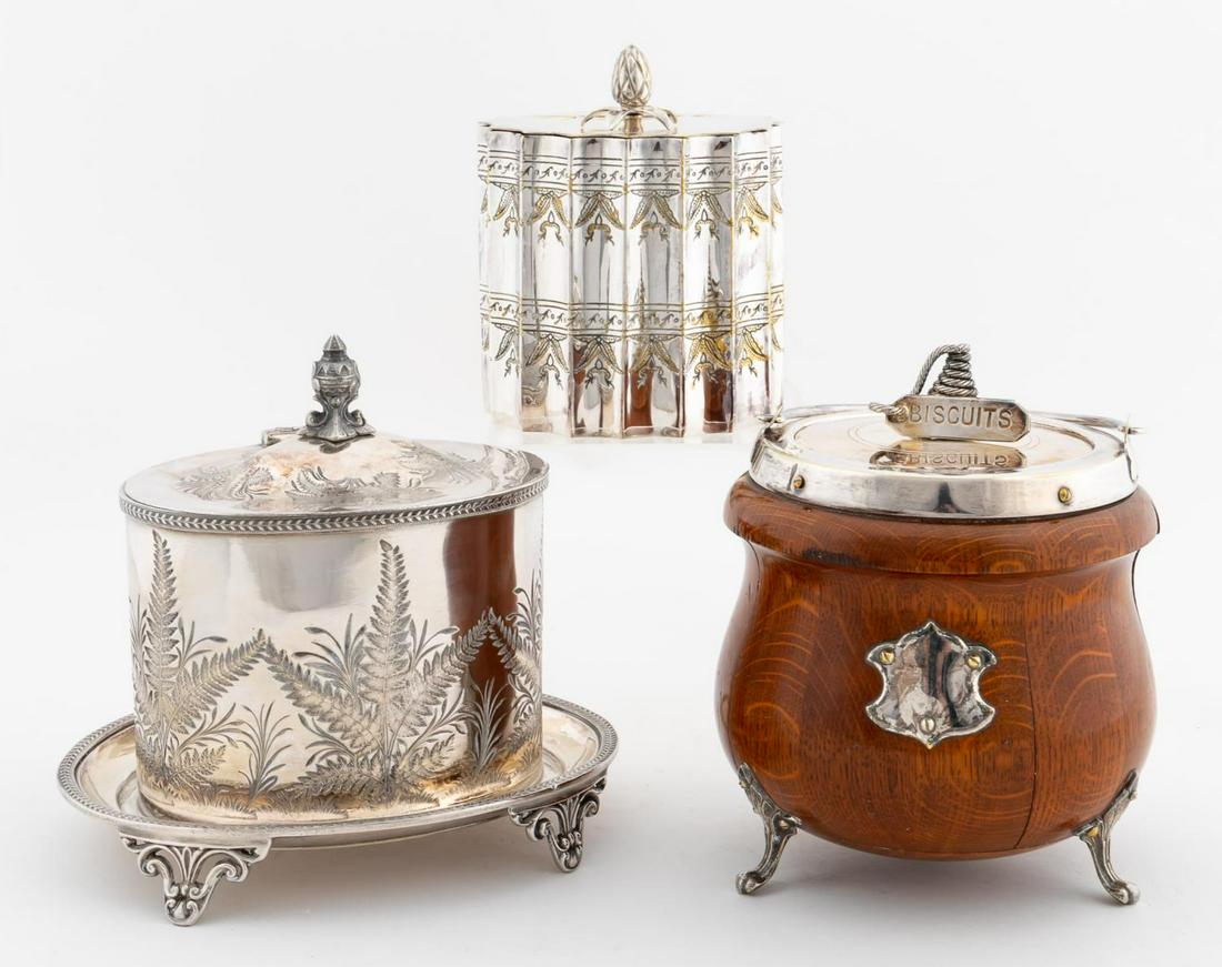 3PCS, ENGLISH BISCUIT BARRELS, SILVERPLATE & OAK: British, late 19th/20th century. Group of three English biscuit barrels comprising silverplate bearing the mark of William Humphries and Co (h. 7.25" ), silverplate (h. 6"), and oak silverplate mounte