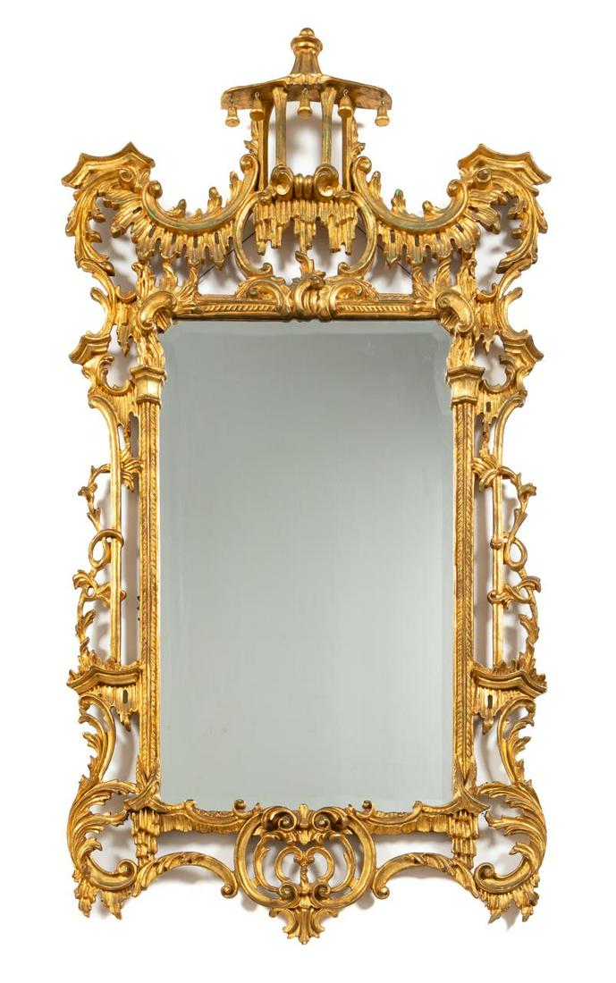 CHINESE CHIPPENDALE GILTWOOD WALL MIRROR: Continental. Giltwood Chinese Chippendale style mirror incorporating acanthus leaf C and S scrolls, a pagoda and articulated accents. Apparently unmarked. Approx. h. 59", w. 31.5".
