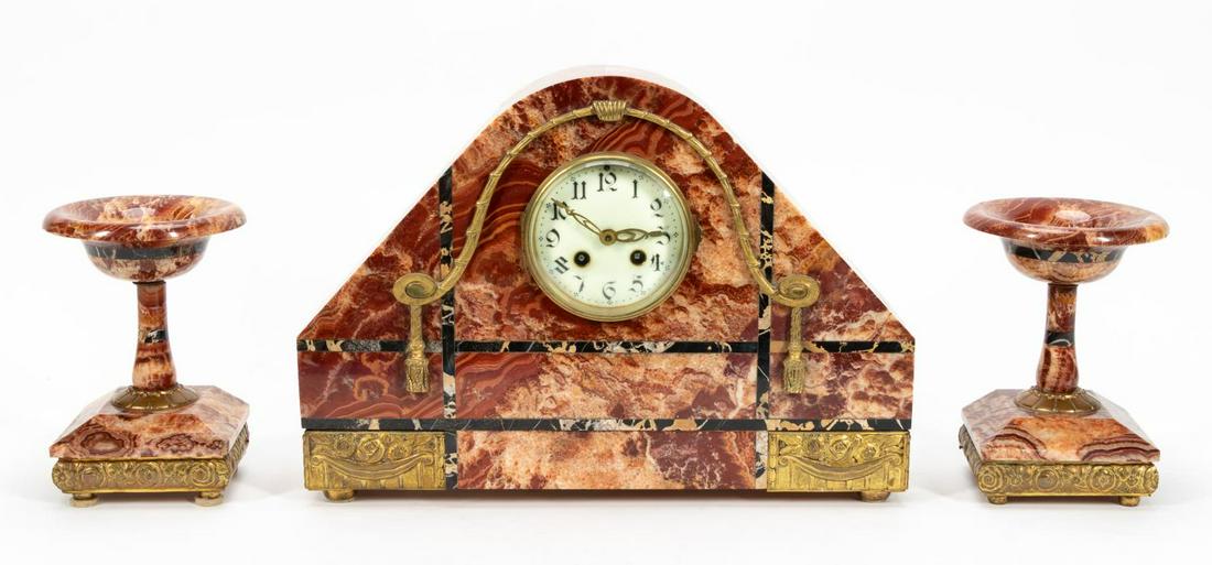 THREE PIECE ART DECO MARBLE CLOCK & GARNITURE SET: French, 20th century. A three piece Art Deco clock and garniture set in variegated red and black marble with highly decorative ormolu mounts. Apparently unmarked. Approx. h. 11.75", w. 16.5", d. 4.25"