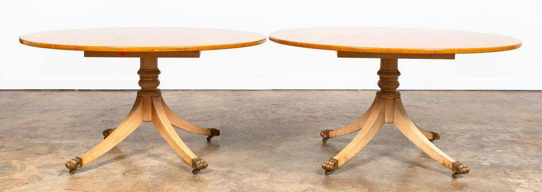 PR., MAISON JANSEN STYLE BLONDE WOOD ROUND TABLES: Style of Maison Jansen (French), 20th century. Pair of carved circular Regency style center tables with splayed legs on brass paw feet with casters. Apparently unmarked. Approx. h. 28.5", diam. 55".