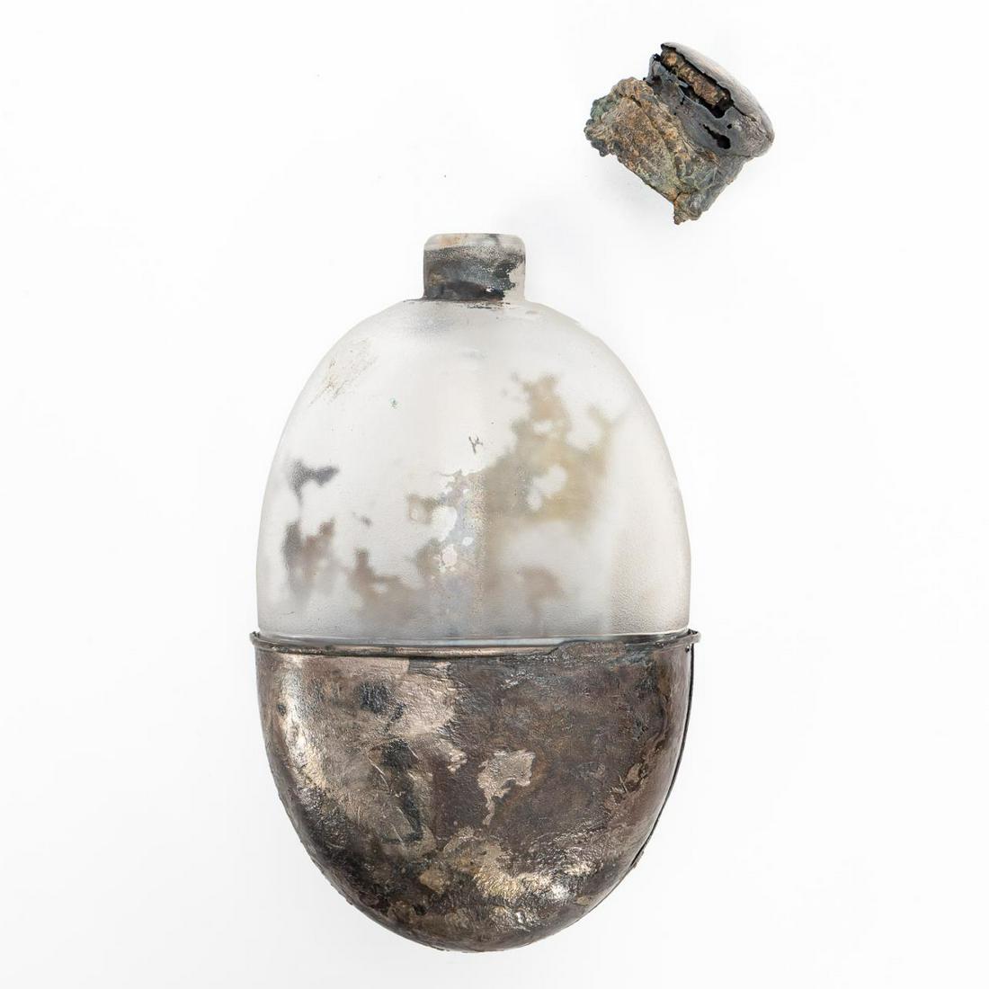 RMS CARPATHIA, SALVAGED GLASS & METAL FLASK: RMS Carpathia, Cunard Line, maiden voyage May 5, 1903; sunk July 15, 1918. Salvaged glass and metal flask with cap, the metal casing formerly with leather cover and has a faint pattern of a wine glass