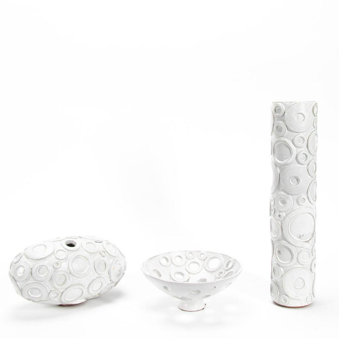 3PCS JONATHAN ADLER BESPOKE POTTERY, CIRCLE MOTIF: Jonathan Adler (American), c. 2001. Group of three Couture circle motif pottery pieces comprising of one tall vase one footed bowl and oval form vase. Signed and impressed maker's mark to underside. A