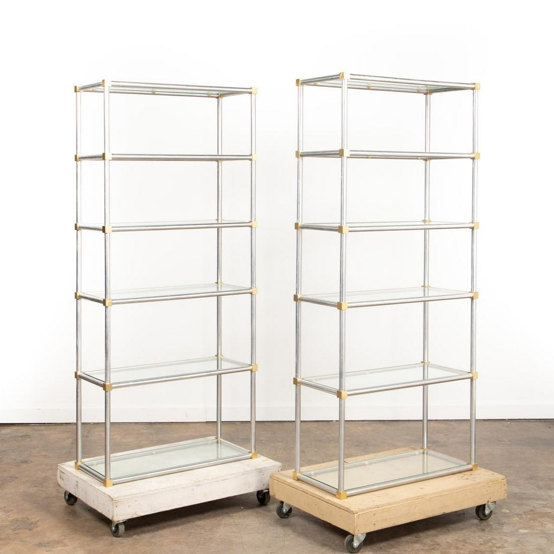 PAIR, MAISON JANSEN STYLE CHROME & BRASS ETAGERES: Style of Maison Jansen (French), mid 20th century. Pair of Hollywood Regency style chrome and glass etageres with brass cube accents. Apparently unmarked. Approx. h. 72.25", w. 32.625", d. 13.625".