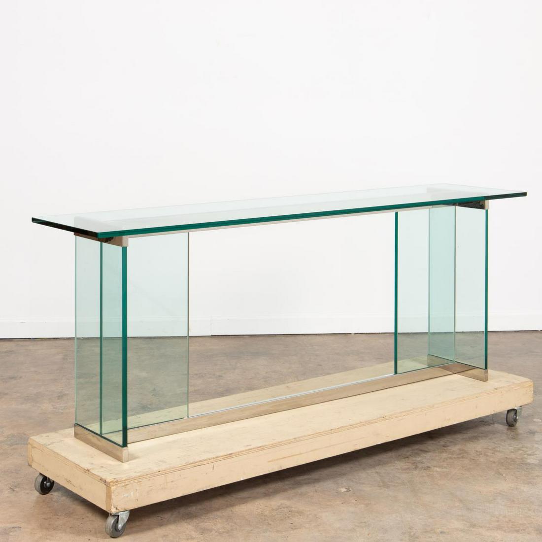 20TH C. MODERNIST GLASS AND CHROME CONSOLE TABLE: American, second half 20th century. Pace collection style glass and chrome console table Apparently unmarked. Provenance: From the Estate of Richard D. and Gail M. Royston of Atlanta, Georgia. Approx.