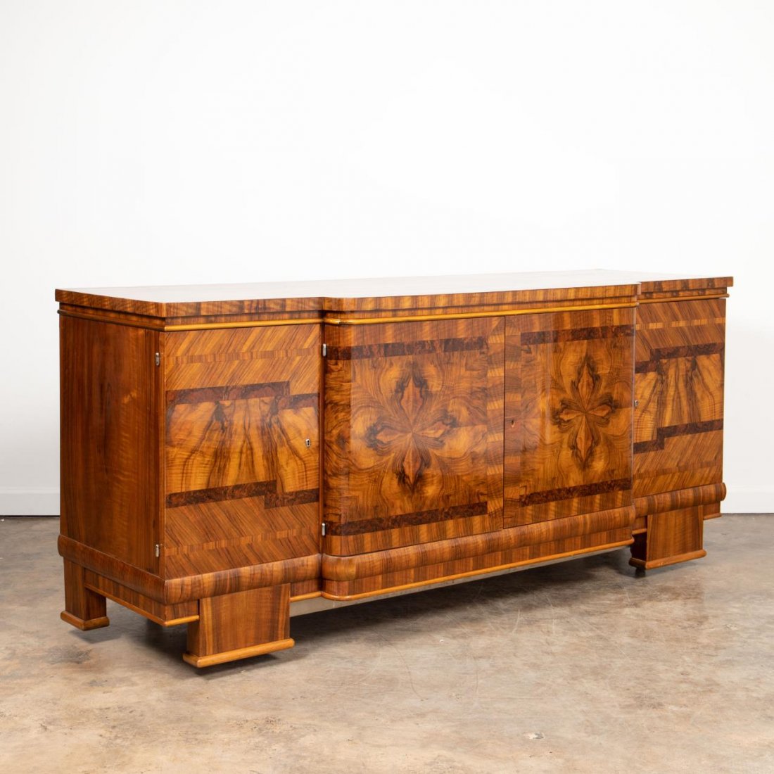 E. 20TH C. ART DECO STYLE BURLED WOOD BUFFET: Continental, second quarter 20th century. Art deco style block front sideboard / credenza having ornately veneered body with various woods including burled walnut. Stamp to back. Approx. h. 39.875", w