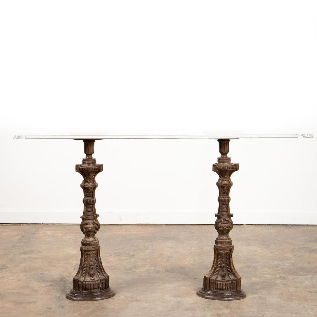 CANDLE PRICKET CONSOLE TABLE WITH LUCITE TOP: Continental, 19th century. Pair of carved wooden altar candle prickets, in the baroque taste, now converted into a console table and having a rectangular Lucite top. Unmarked. Provenance: From the Est