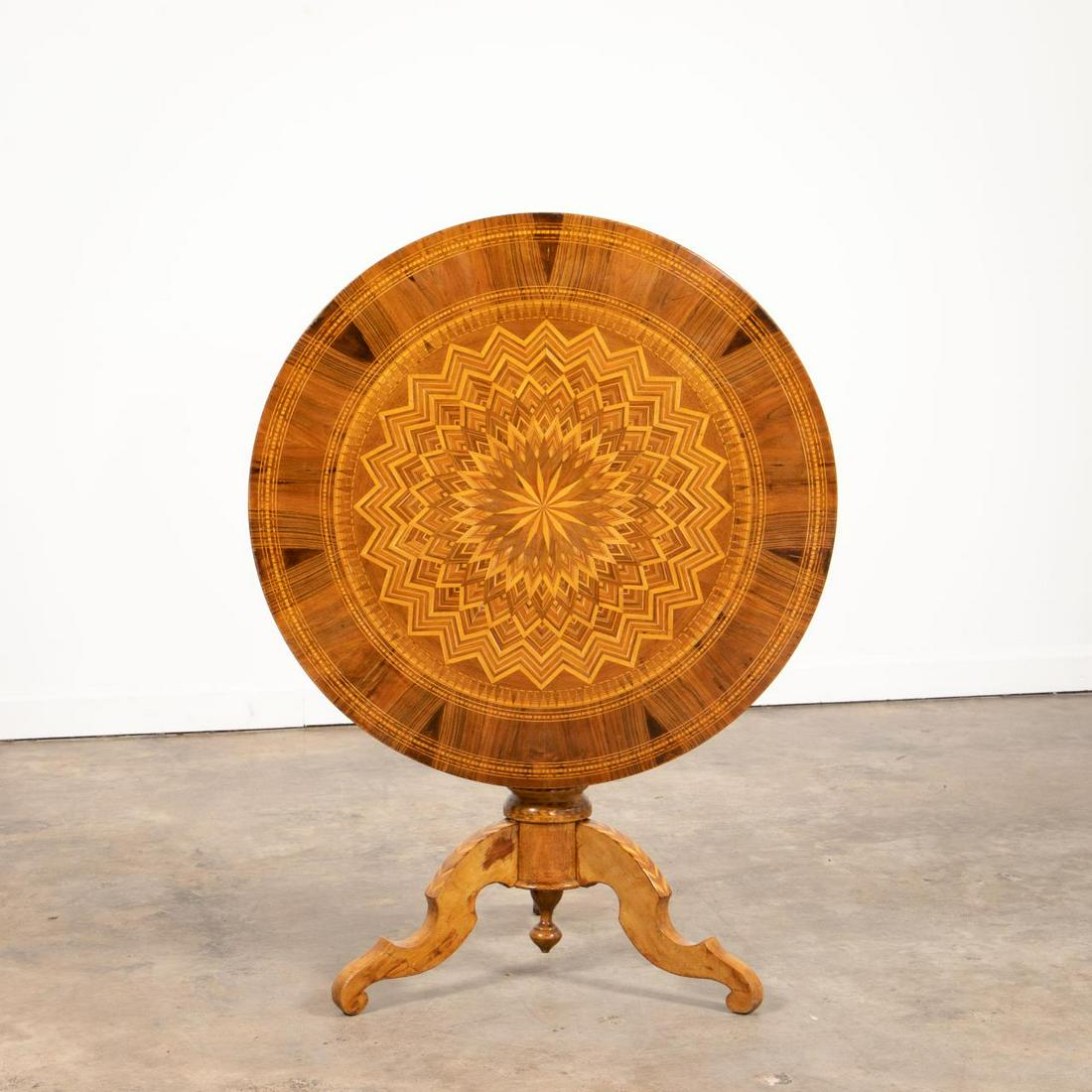 19TH C. EUROPEAN PARQUETRY INLAID TABLE: European, late 19th to early 20th century. Mixed wood inlaid parquetry tilt-top table, having a radiating star pattern, and rising on an inlaid on a pedestal base with curved legs. Stenciled '7' and i