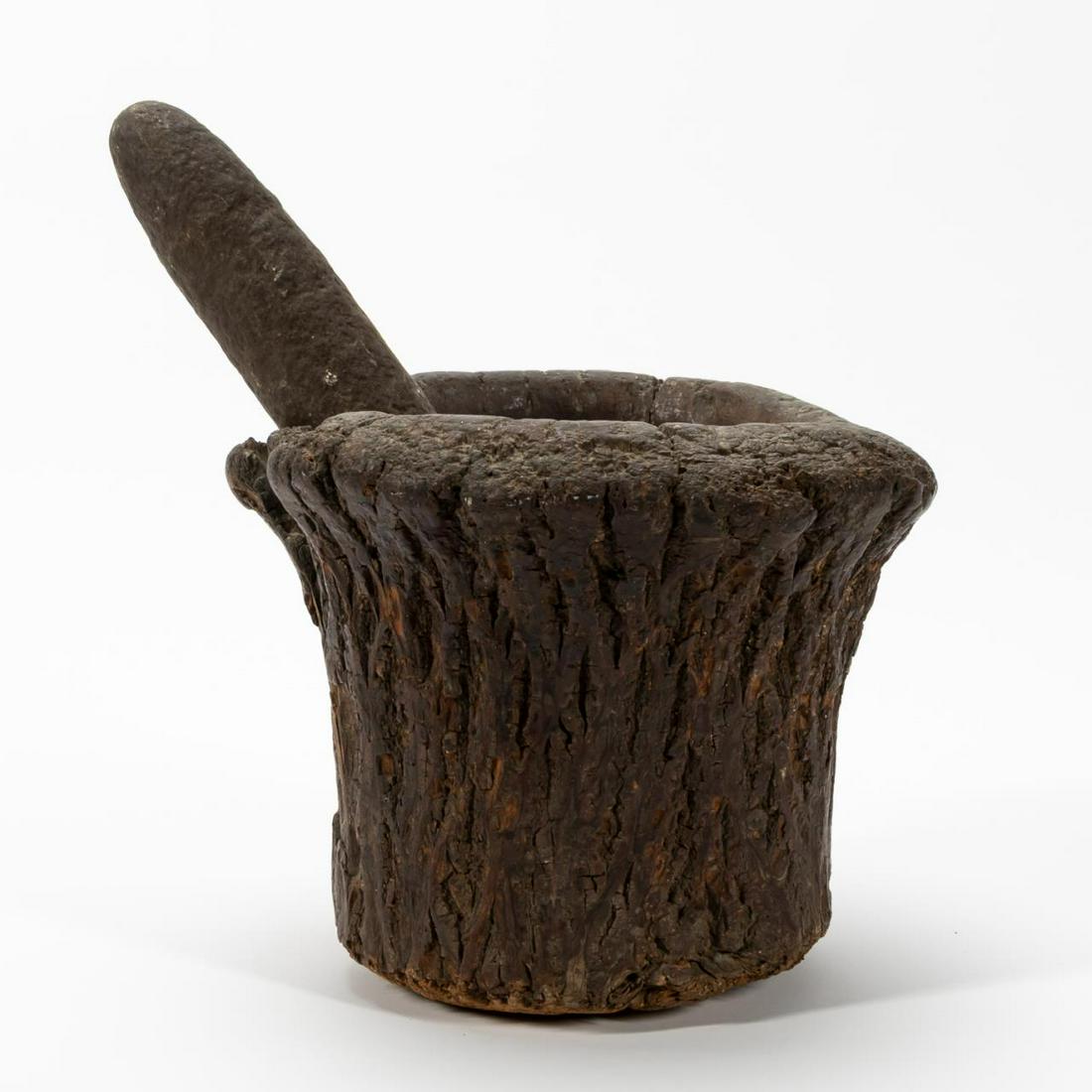 2PC, LARGE CARVED WOODEN MORTAR & STONE PESTLE: Possibly Native American. Large carved rustic wooden mortar fashioned from a tree trunk together with a stone pestle. Unmarked. Approx. of the mortar, h. 8", dia. 8.5".