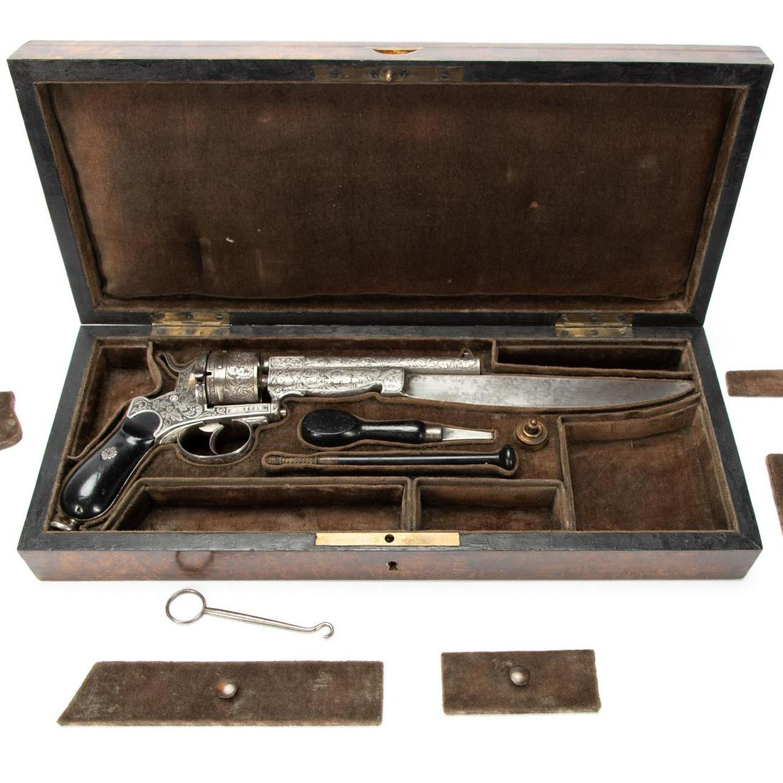 19TH C. PINFIRE REVOLVER WITH BAYONET & CASE: Belgian, circa 1811-1892. 10.35 caliber pinfire revolver with heavy etched foliate decoration and attached bowie knife. Accompanied by case and accessories including turnscrew, ramrod with cleaning ja