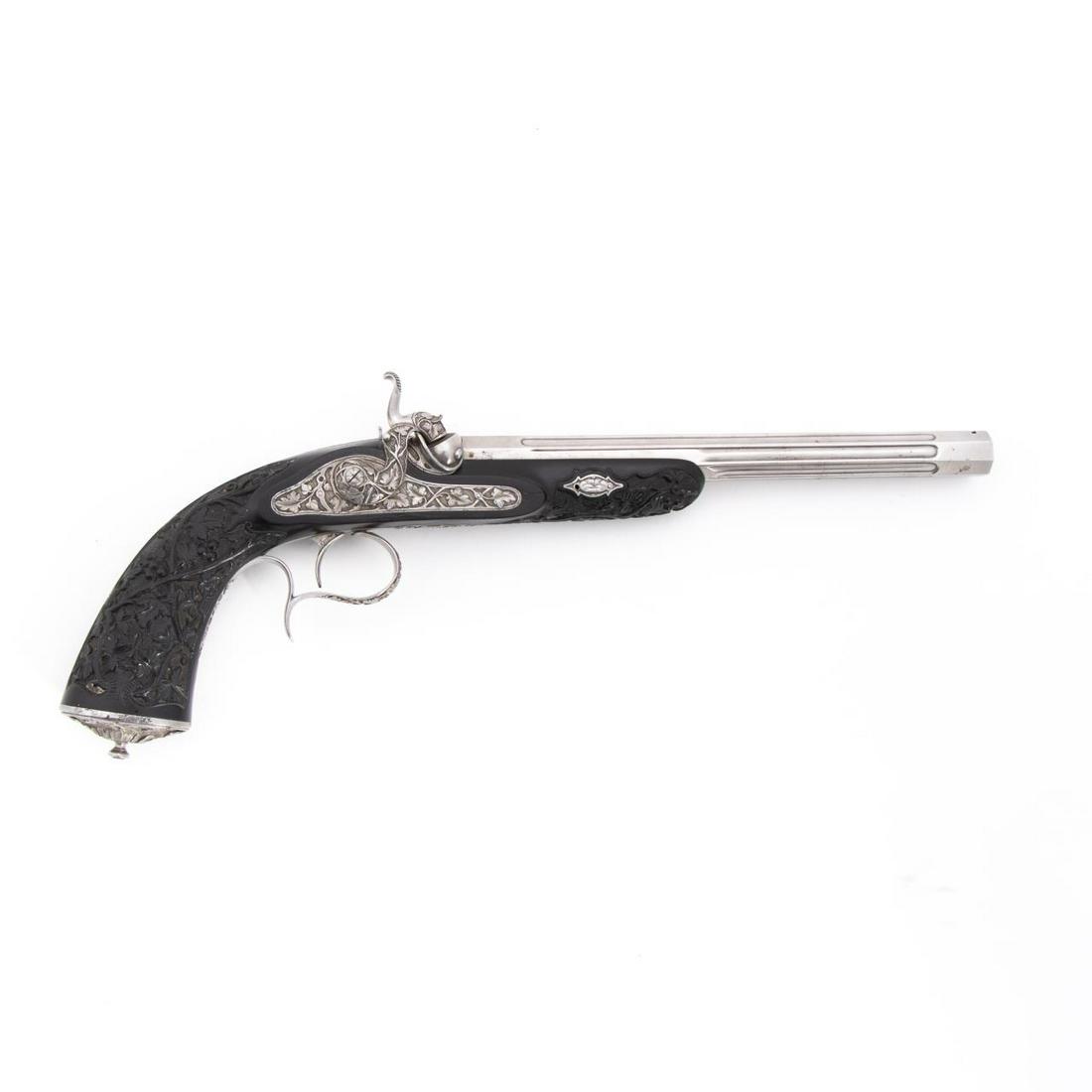 MID-19TH C. LIEGE CARVED EBONY PERCUSSION PISTOL: Belgian, likely liege, circa 1860. Ornate 11 mm caliber percussion pistol having octagonal fluted barrel, relief decorated lock plate and trigger guard ,and a highly carved ebony stock with oval pomme