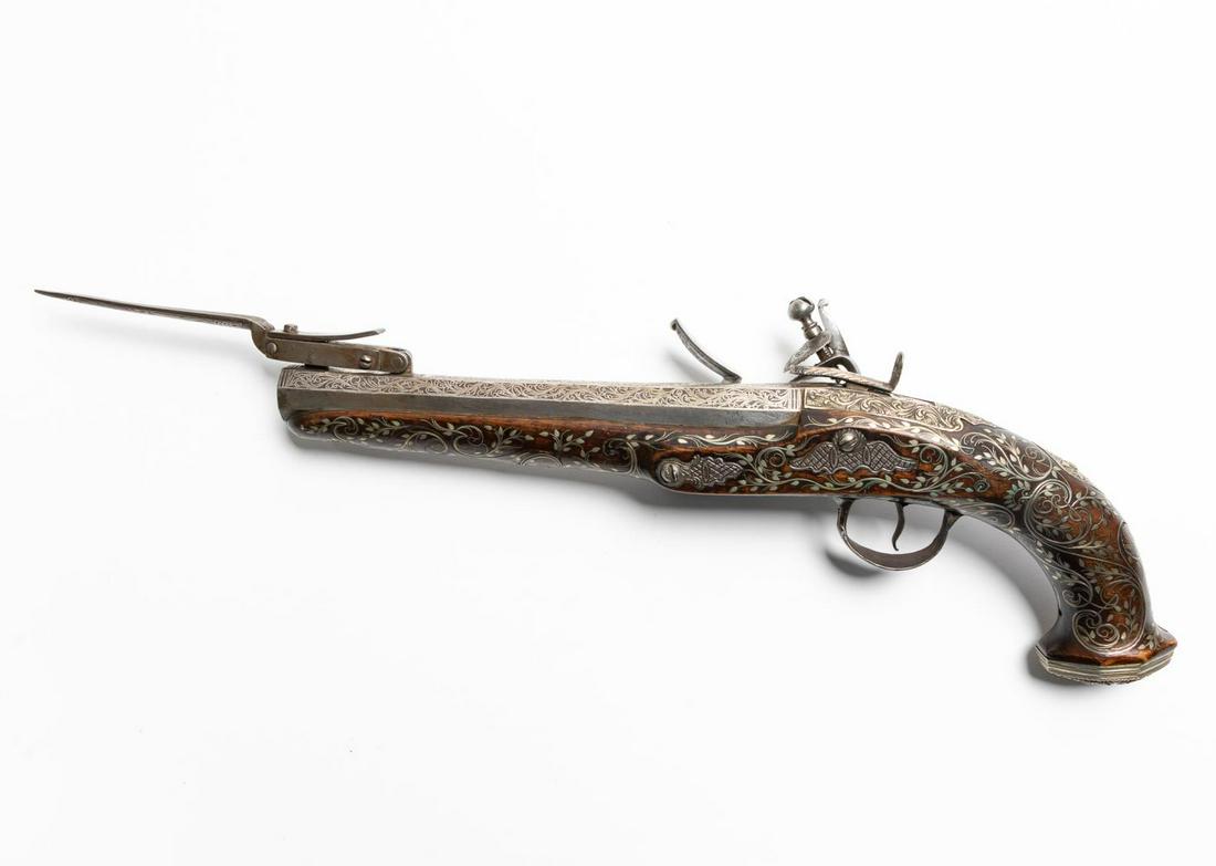E. 19TH C. OTTOMAN SILVER INLAID FLINTLOCK PISTOL: North African / Ottoman, circa 1830 / 1840. Silver filigree inlaid flintlock pistol with spring bayonet havi Provenance: Acquired from Hermann Historica on May 15-19th, 2019, lot 1663, for 1900 euro. 